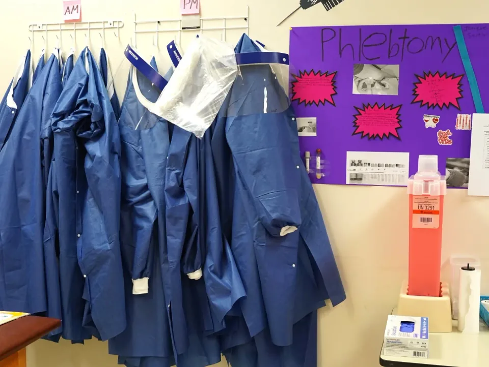 Phlebotomy lab with student gowns, face shields, and lab supplies at National Career Education's Citrus Heights campus