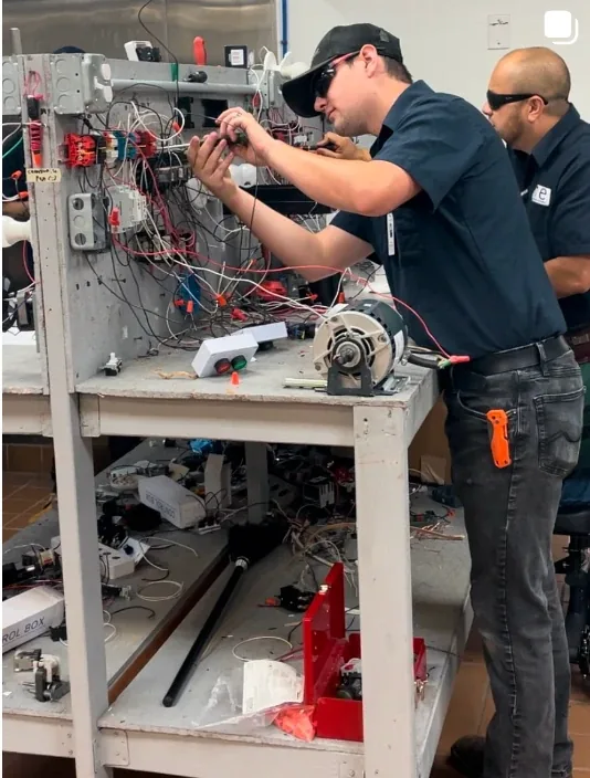 NCE Electrician student working on a motor controls trainer