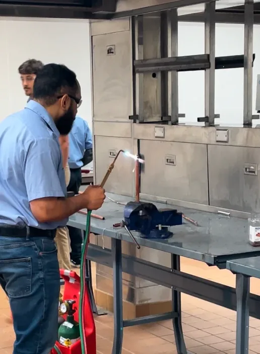 NCE HVAC student practicing copper brazing