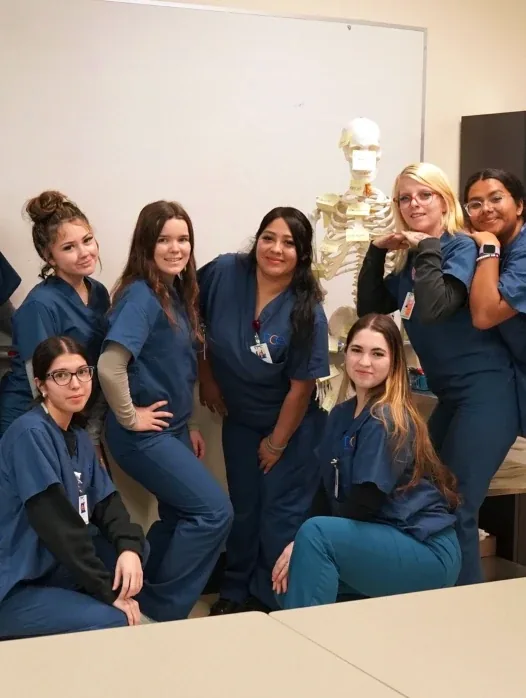 NCE Medical Assistant class with an anatomy skeleton