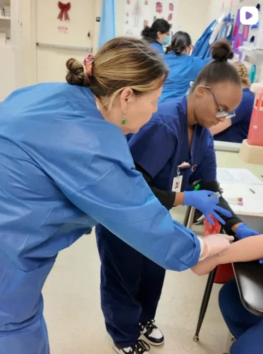 NCE phlebotomy students practicing on campus